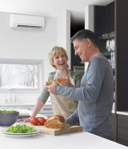 man and woman in room with ductless mini split system installation